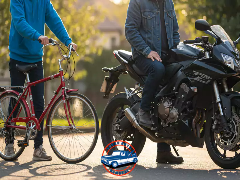 Two men next to a red bicycle and a black motorcycle on a sunny residential street.